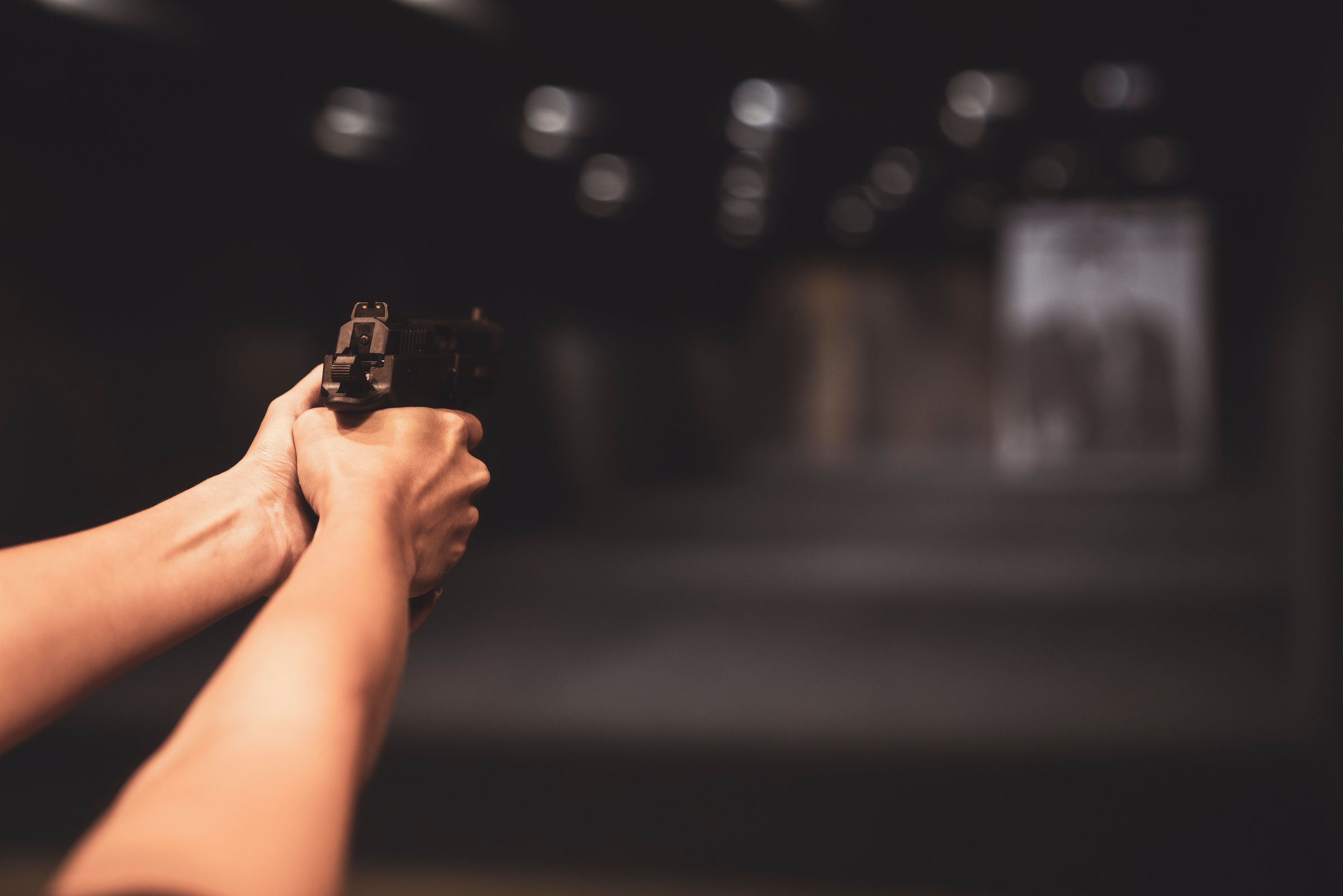 Shooting with Gun at Target in Shooting Range